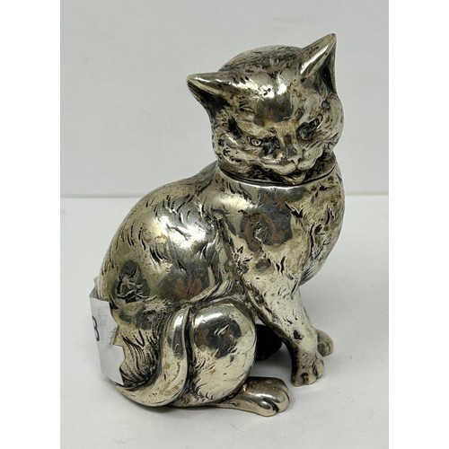 219 - A novelty silver jar and cover, in the form of a cat, 7 cm high, and a small silver chick, 2 cm high... 