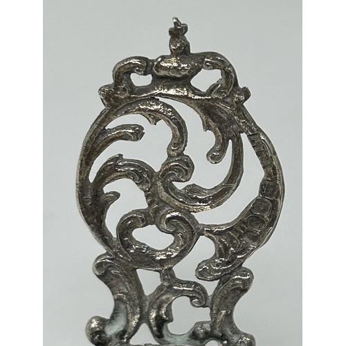 221 - A novelty silver ornament, of a baby in a bassinette, a miniature table and chairs (3)