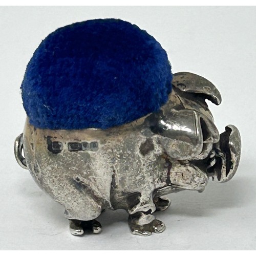 227 - A novelty silver pin cushion, in the form of a pig, marks rubbed, 2.5 cm wide