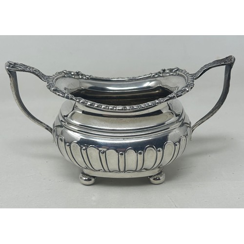 19 - A George V silver bachelor teapot with an ebonised handle, and matching sugar bowl, London 1909, all... 