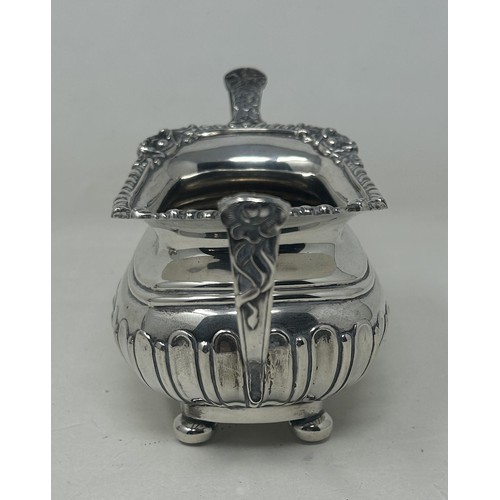 19 - A George V silver bachelor teapot with an ebonised handle, and matching sugar bowl, London 1909, all... 