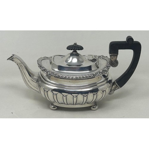 19 - A George V silver bachelor teapot with an ebonised handle, and matching sugar bowl, London 1909, all... 