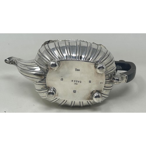 19 - A George V silver bachelor teapot with an ebonised handle, and matching sugar bowl, London 1909, all... 