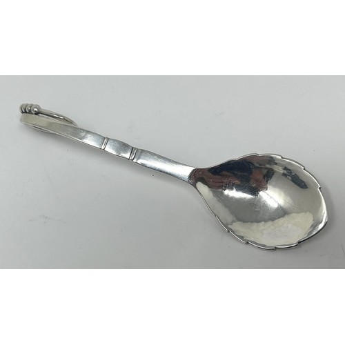 122 - A Danish silver coloured metal spoon, by Georg Jensen, 32.4 g