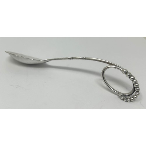 122 - A Danish silver coloured metal spoon, by Georg Jensen, 32.4 g