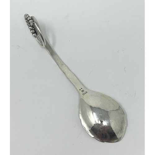 122 - A Danish silver coloured metal spoon, by Georg Jensen, 32.4 g