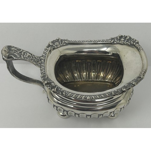 123 - A George V silver cream jug, and two silver napkin rings, various dates and marks, 9.3 ozt (3)