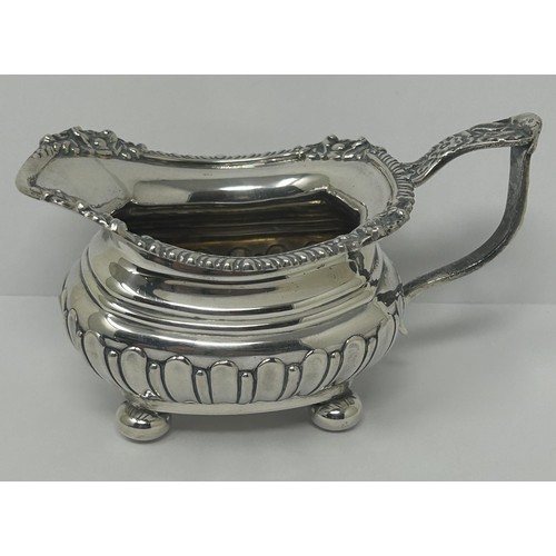 123 - A George V silver cream jug, and two silver napkin rings, various dates and marks, 9.3 ozt (3)