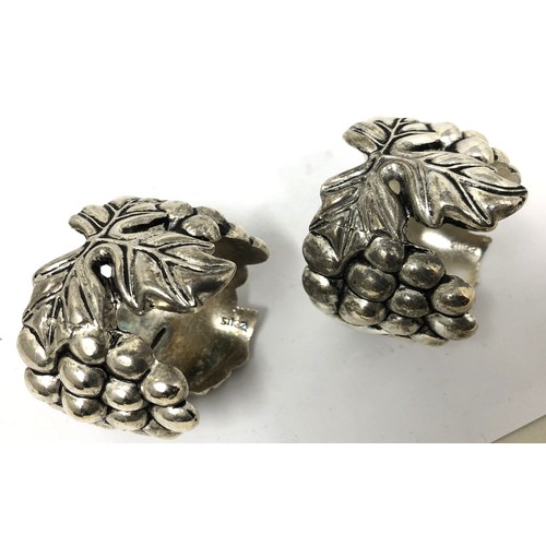 212 - A pair of Continental silver coloured metal novelty napkin rings, in the form of grapes and vines, a... 