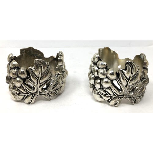 212 - A pair of Continental silver coloured metal novelty napkin rings, in the form of grapes and vines, a... 