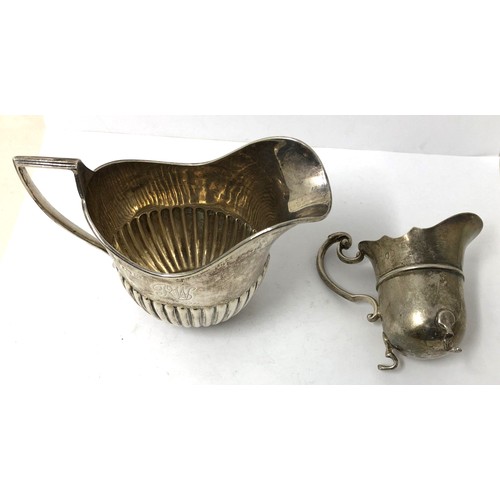 213 - A George V silver cream jug, Birmingham 1922, and another smaller silver cream jug, 6.33 ozt (2)