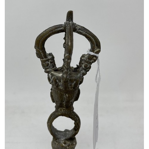 940 - An Indo-Chinese style hand bell, 17.5 cm high, with a clapper