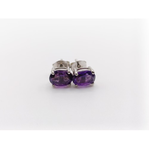 450 - A pair of amethyst studs, in silver