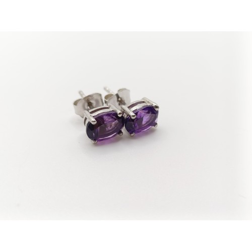 450 - A pair of amethyst studs, in silver