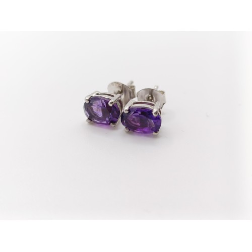 450 - A pair of amethyst studs, in silver