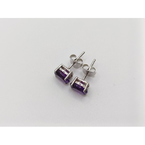 450 - A pair of amethyst studs, in silver