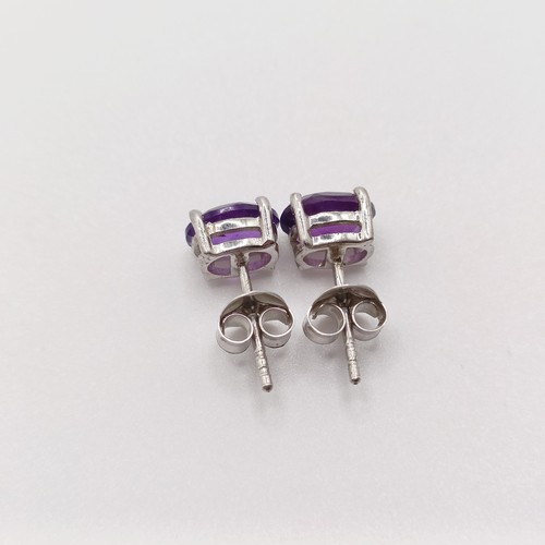 450 - A pair of amethyst studs, in silver