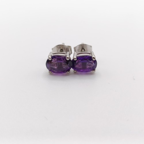 450 - A pair of amethyst studs, in silver