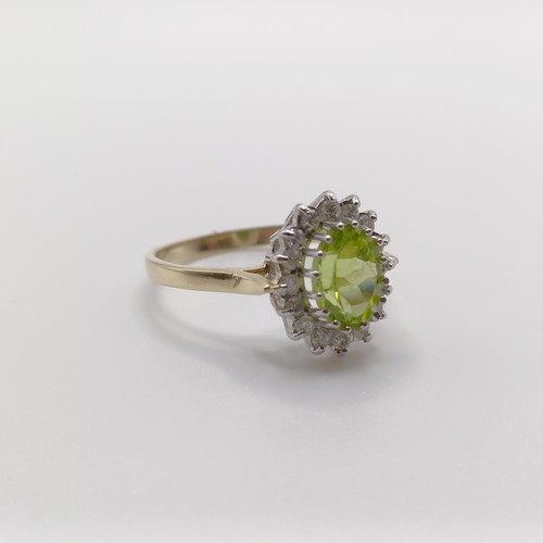 421 - A 9ct yellow and white gold cluster ring, set with an oval-cut peridot and RBC diamonds, size N 1/2