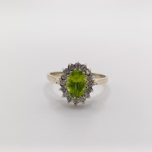 421 - A 9ct yellow and white gold cluster ring, set with an oval-cut peridot and RBC diamonds, size N 1/2