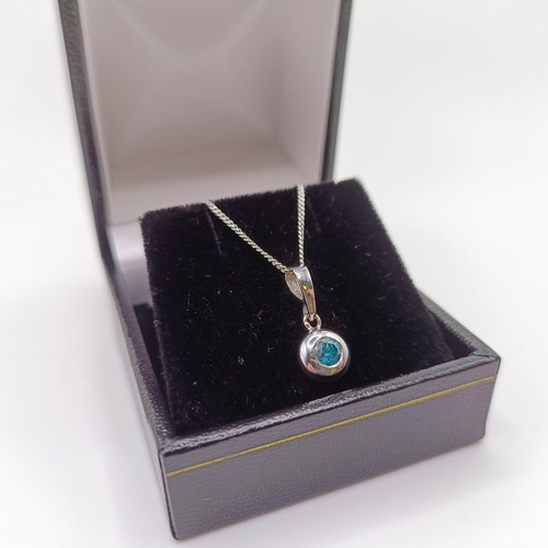 422 - A 14ct white gold and blue diamond pendant, with a silver chain, boxed, RBC diamond 0.20ct