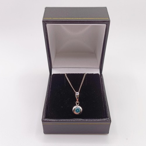 422 - A 14ct white gold and blue diamond pendant, with a silver chain, boxed, RBC diamond 0.20ct