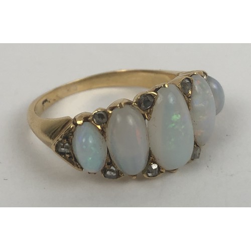 426 - A gold and five stone opal ring, ring size N