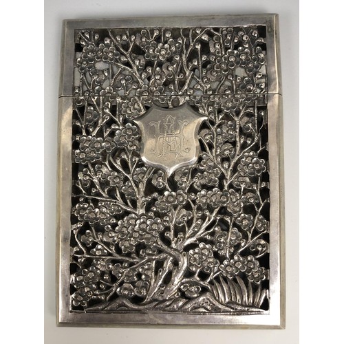 293 - A Chinese silver coloured metal visiting card case, initialled, pierced prunus decoration, 11.5 cm