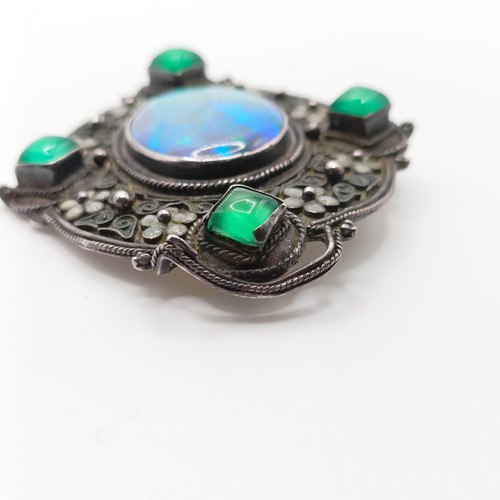 409 - An Arts and Crafts silver coloured metal, opal, green stone and enamel brooch, by Jean Bassett  Prov... 