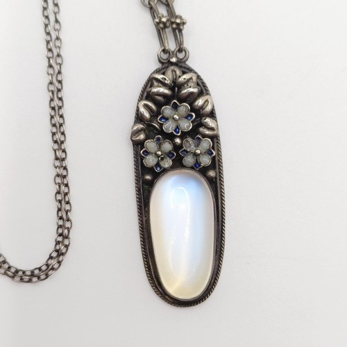 407 - An Arts and Crafts silver coloured metal and moonstone pendant, on a chain, by Jean Bassett Provenan... 