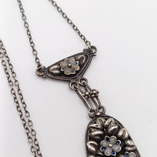 407 - An Arts and Crafts silver coloured metal and moonstone pendant, on a chain, by Jean Bassett Provenan... 