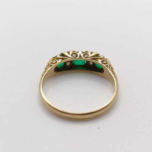 424 - An 18ct gold, emerald and diamond ring, ring size O