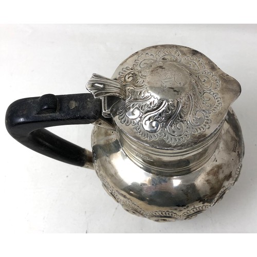 203 - A Victorian silver hot water jug, with an ebonised handle