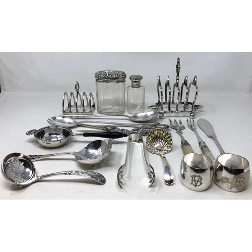 231 - A George V silver tea strainer, 1.5 ozt , two silver topped glass bottles, and assorted silver plate... 