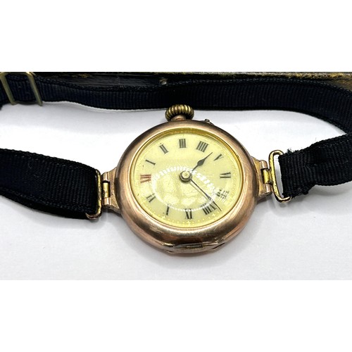 368 - A ladies yellow coloured metal wristwatch, on a silk strap, with a worn vintage watch box, and a lad... 