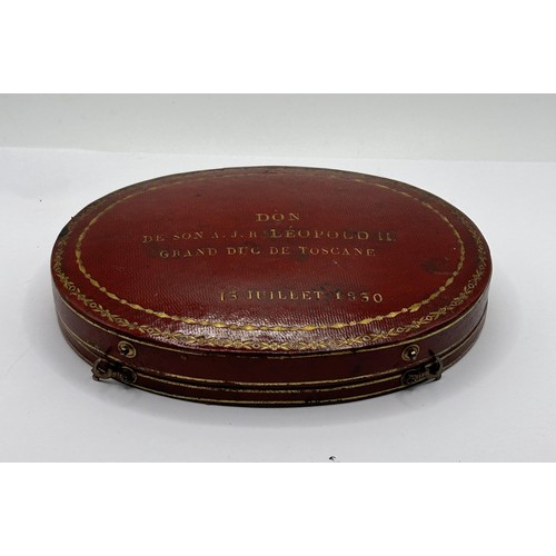 379 - An early/mid 19th century French oval box, to hold two pocket watches, the cover tooled in gilt 'DON... 