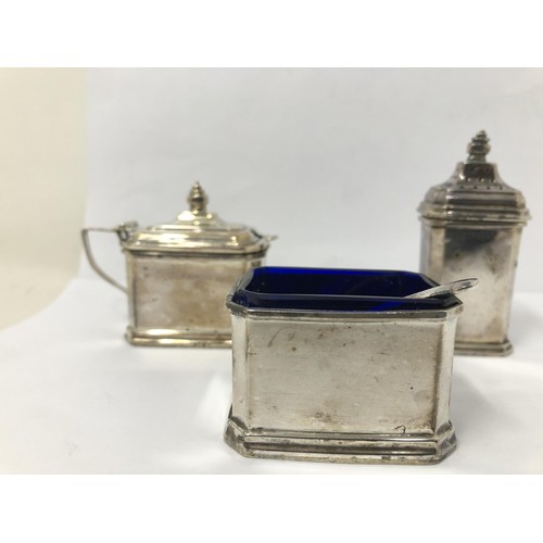 254 - An extensive George V silver cruet set, comprising four pepperpots, four mustard pots, four salts, a... 