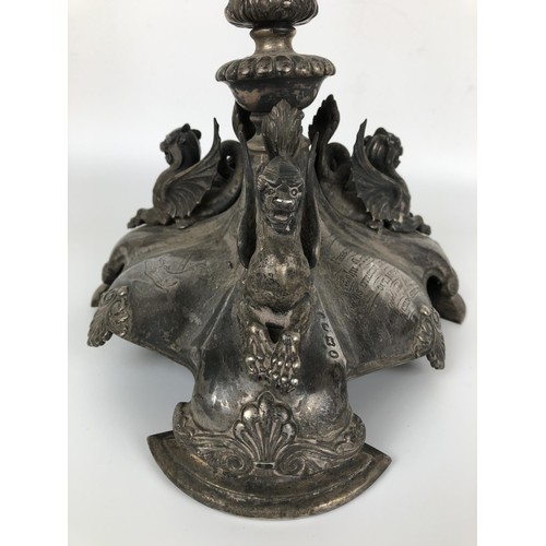 261 - A Victorian silver candelabrum, lacking one branch, the base with griffin mounts, with a presentatio... 