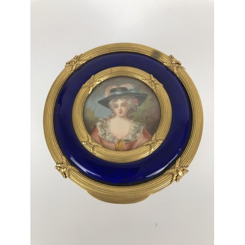 264 - An impressive early 20th century gilt metal and blue enamel dressing table set, inset with portrait ... 