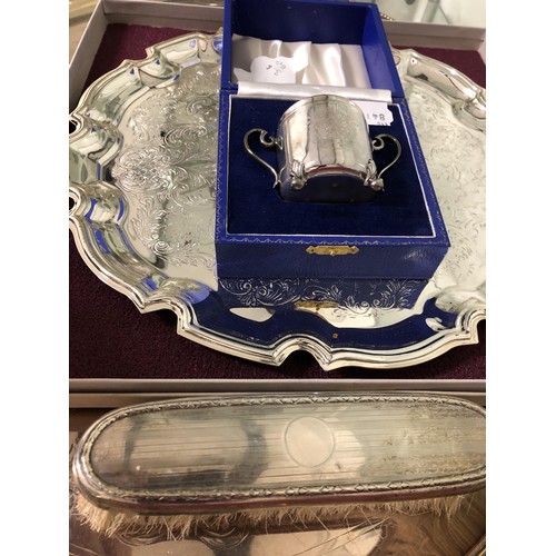 287 - An Elizabeth II cup and cover, 3.5 ozt, cased, a silver backed brush, a silver plated twin handle tr... 