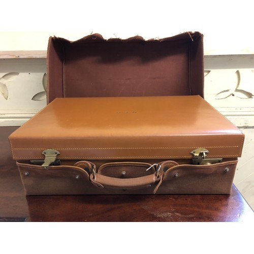 297 - A vintage leather suitcase, inset with various silver topped bottles and silver backed brushes, one ... 