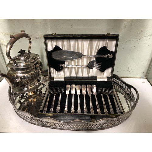 284 - A silver plated kettle on stand, a pair of chambersticks, a set of fish knives and forks, and an ova... 