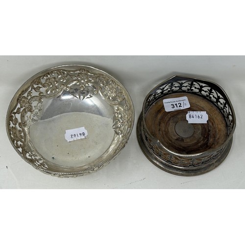 312 - A silver coloured metal pierced bowl, and a silver plated bottle coaster (2)