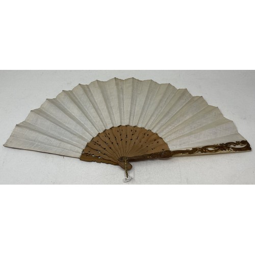 803 - A carved giltwood fan, with pierced decoration, silk decorated butterflies, 10 cm, and two other fan... 