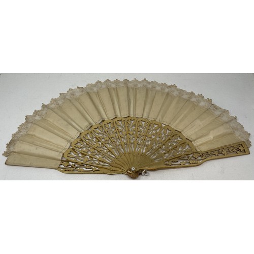 803 - A carved giltwood fan, with pierced decoration, silk decorated butterflies, 10 cm, and two other fan... 