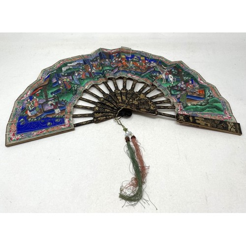 812 - A lacquered fan, decorated figures, paper painted with figures, 22 cm