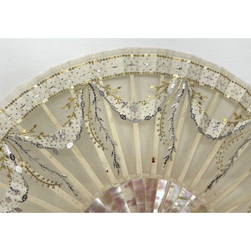 814 - A mother of pearl fan, the lace applied paper festoons, 24 cm