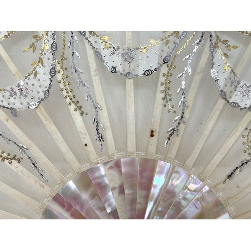 814 - A mother of pearl fan, the lace applied paper festoons, 24 cm