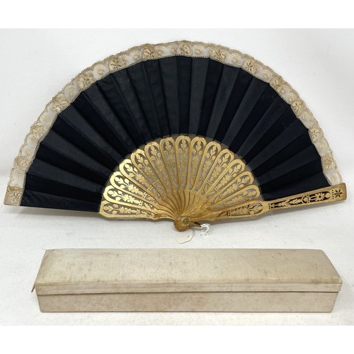 817 - A carved wood fan, silk painted flowers, 25 cm, boxed, and three other fans (4)