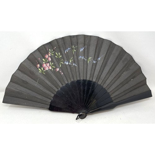 820 - An ebonised fan, the silk painted flowers, 25 cm, boxed, and five other fans (6)